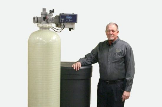 A man in front of a water tank