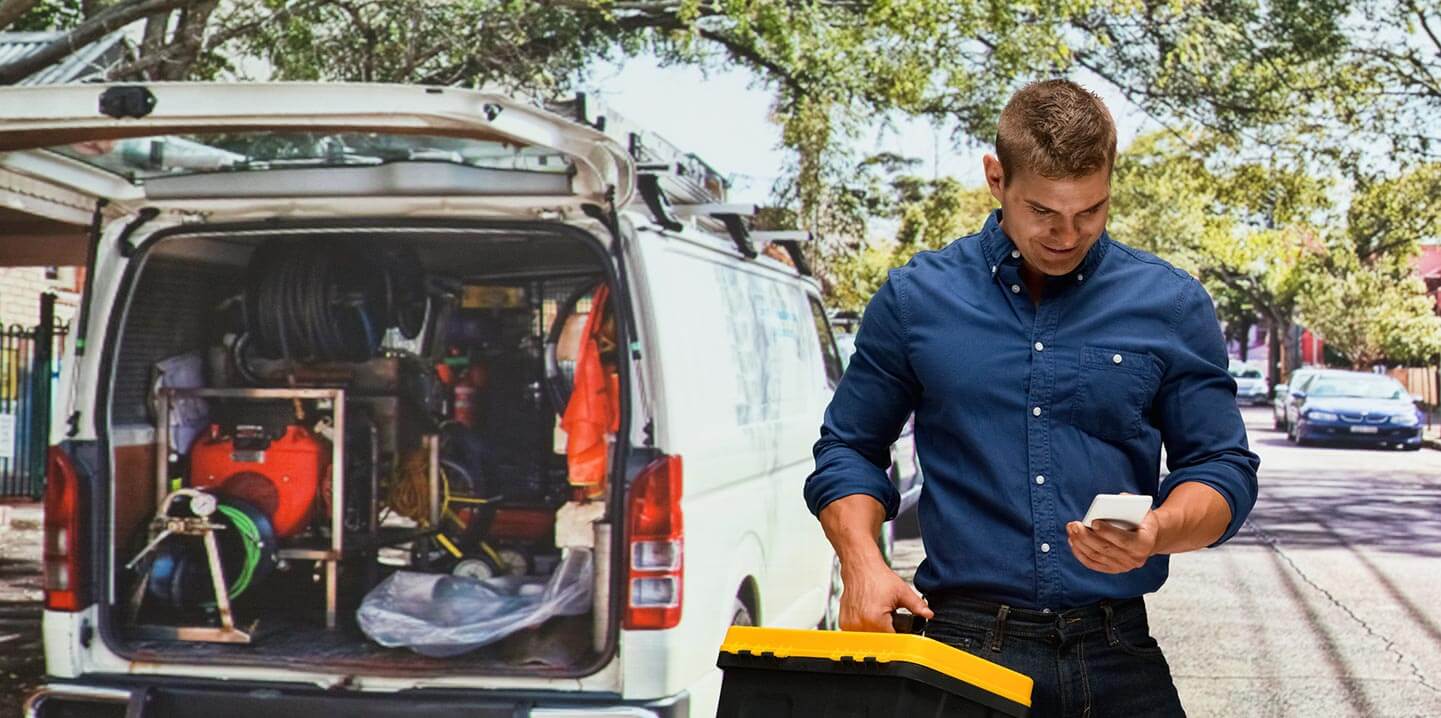 A worker outside of a work truck